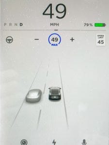 Tesla computer screen showing speed limit and cruise control activation.