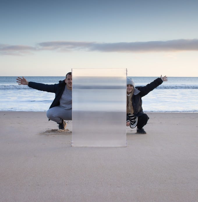 Two people behind invisibility shield Two people behind invisibility shield