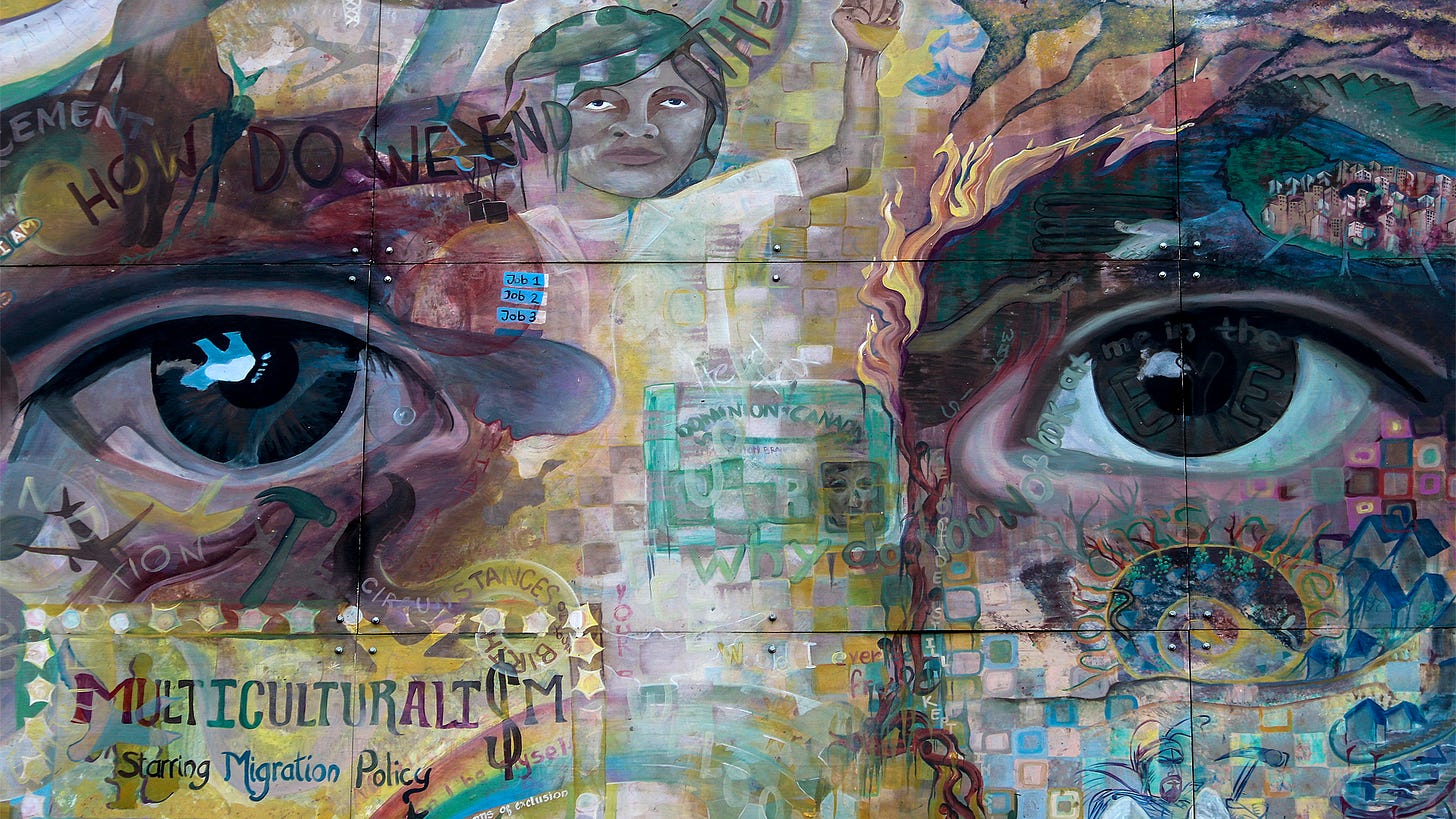 mural depicting two large eyes and face comprised of several smaller images