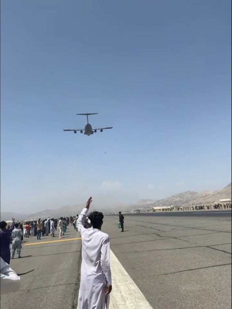 Afghanistani watching a plane take off at Karzai International Airport