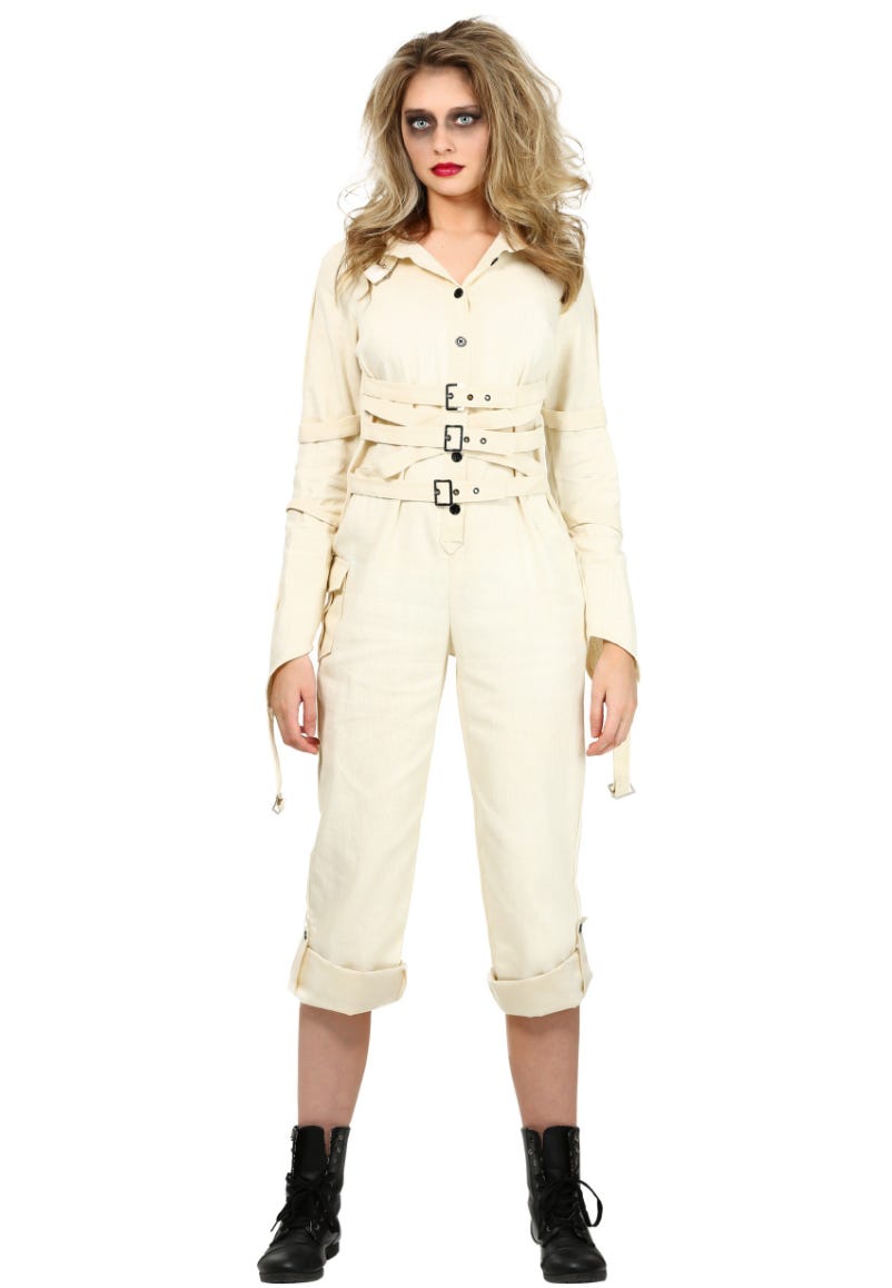 Image is of a thin, conventionally attractive white woman in a white jumpsuit with buckles