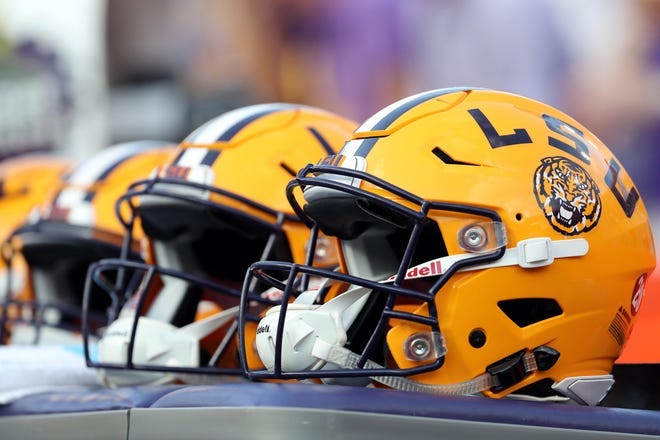 LSU football helmets on the sideline during a game against Florida.