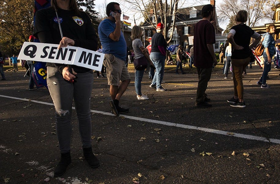 ST PAUL, MN - NOVEMBER 07: A woman holds a sign referencing the QAnon conspiracy as supporters of President Donald Trump gather outside the Governor's Mansion on November 7, 2020 in St Paul, Minnesota. Around the country , supporters of presidential candidate Joe Biden are taking to the streets to celebrate after news outlets have declared Democratic presidential nominee Joe Biden winner over President Donald Trump in the U.S. Presidential race. (Photo by Stephen Maturen/Getty Images)