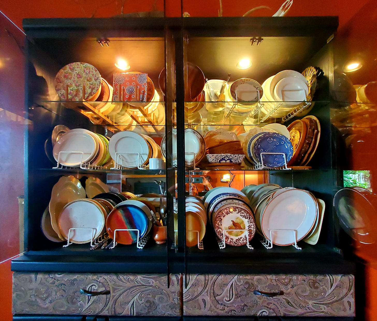 China cabinet full of varied plates and bowls