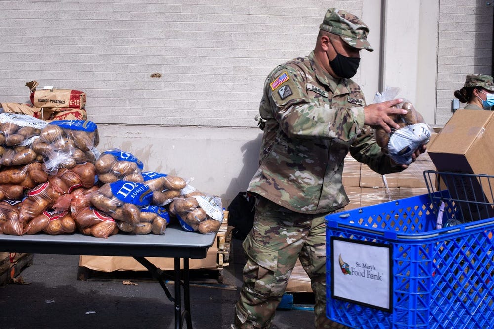 National Guard assist at Phoenix Arizona food-bank while thousands waited in for our car line for aid 