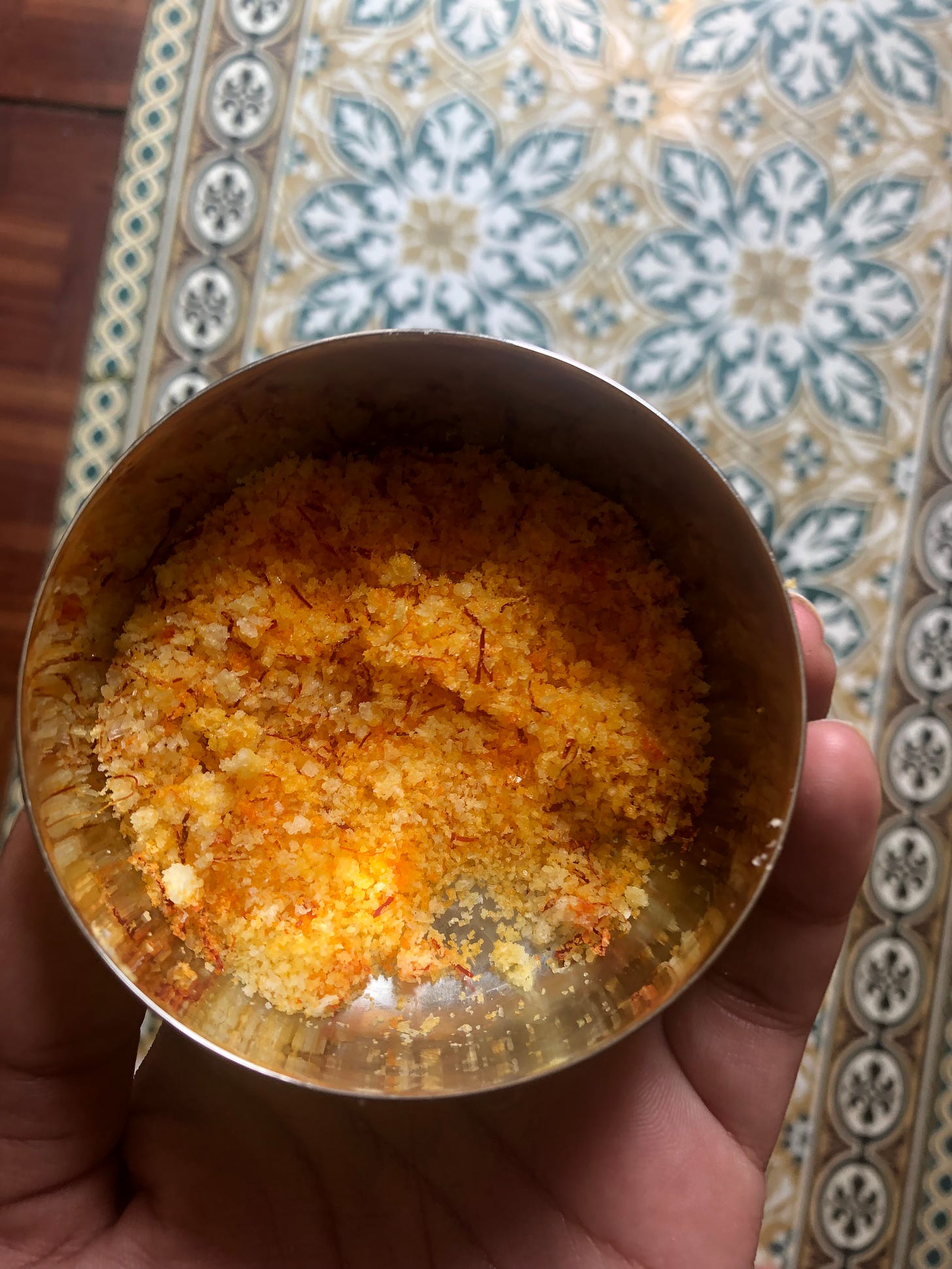 a small metal bowl of saffron salt