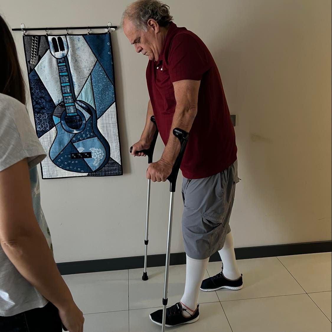 Tom on crutches practicing walking post-surgery. 
