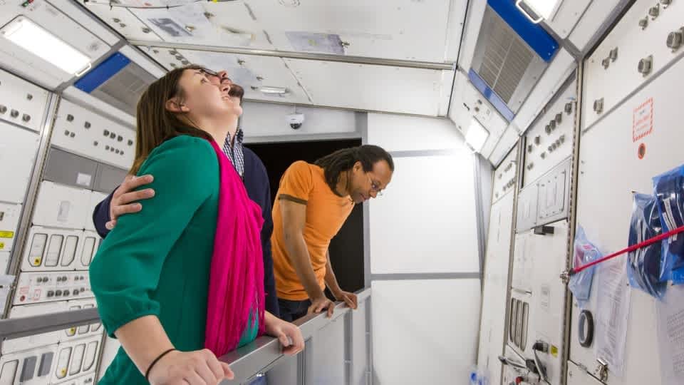 Image of three adults in the Journey to Space exhibit
