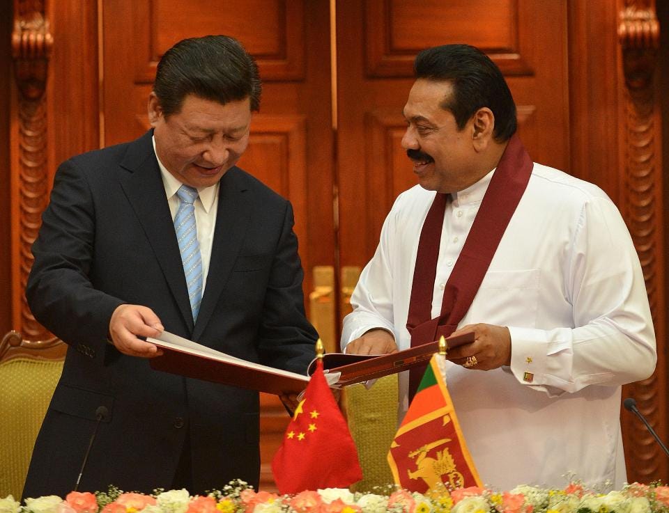 China's President Xi Jinping speaks with Mahinda Rajapaksa