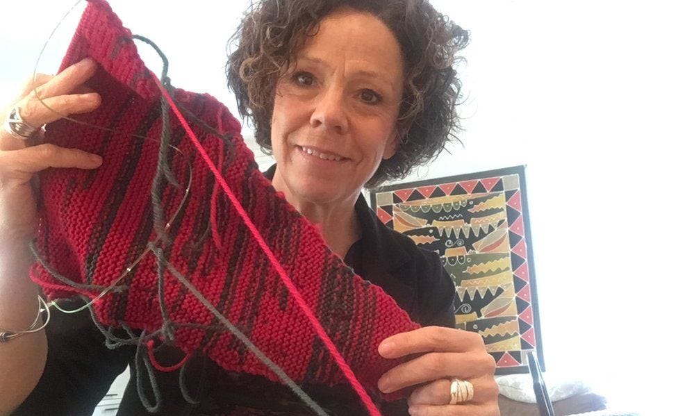 Sue Montgomery holds up her knitting