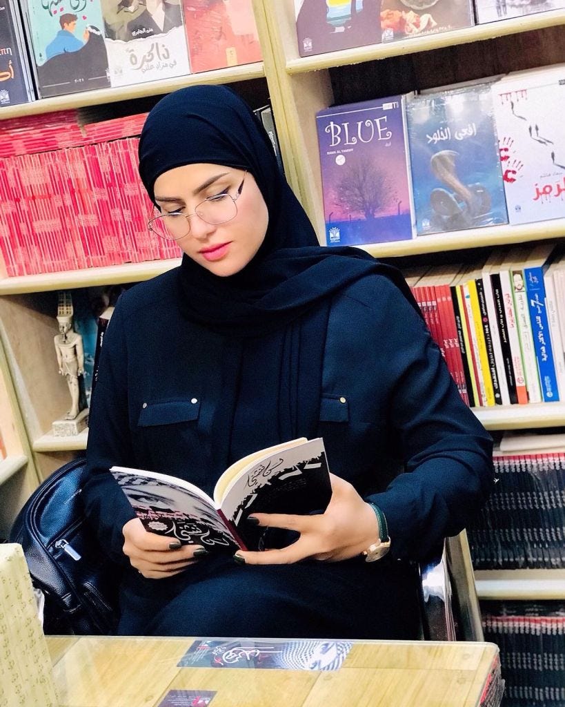 Muna Al Jabri, the female publisher reading a book in Avitoria publishing house