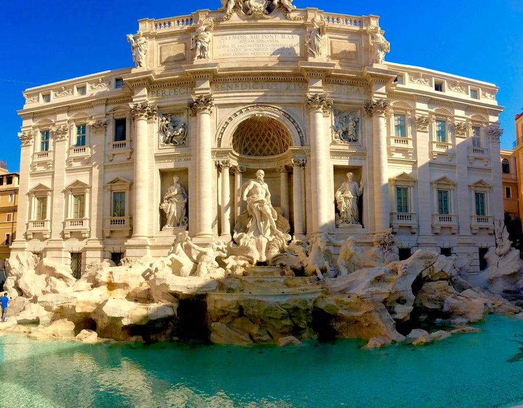 A large white building with statues and a fountain in front of it

Description automatically generated with low confidence