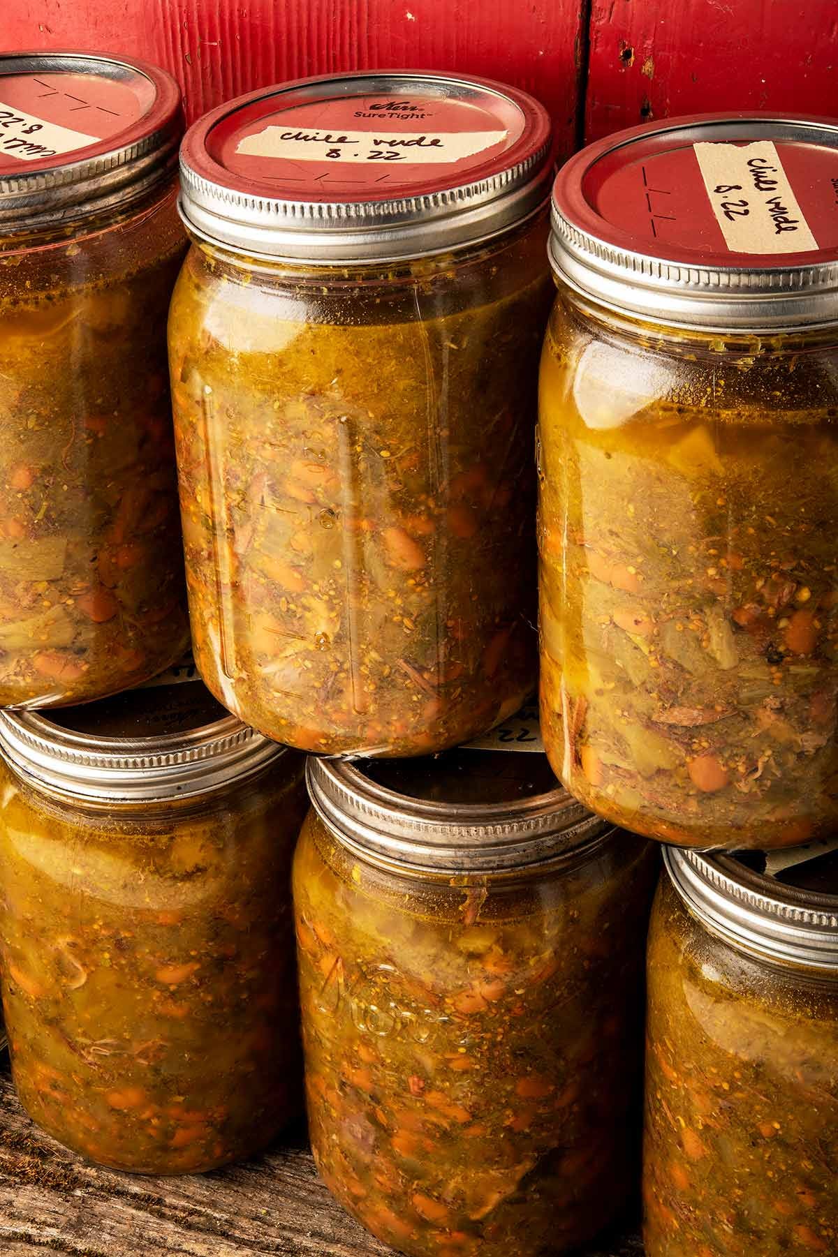 Stacked Mason jars of chile verde. 