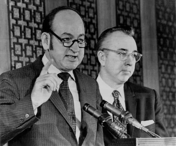 Charls Walker, left, in 1971, explaining new tax laws. With him is John Nolan, the Treasury Department's deputy assistant secretary on tax policy.<br /><br />