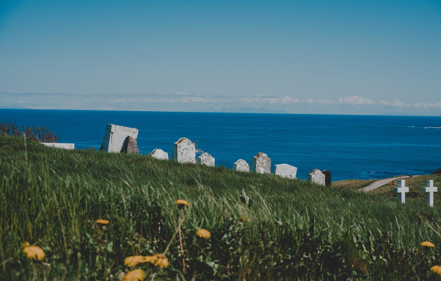 Gravestones, grass, ocean.