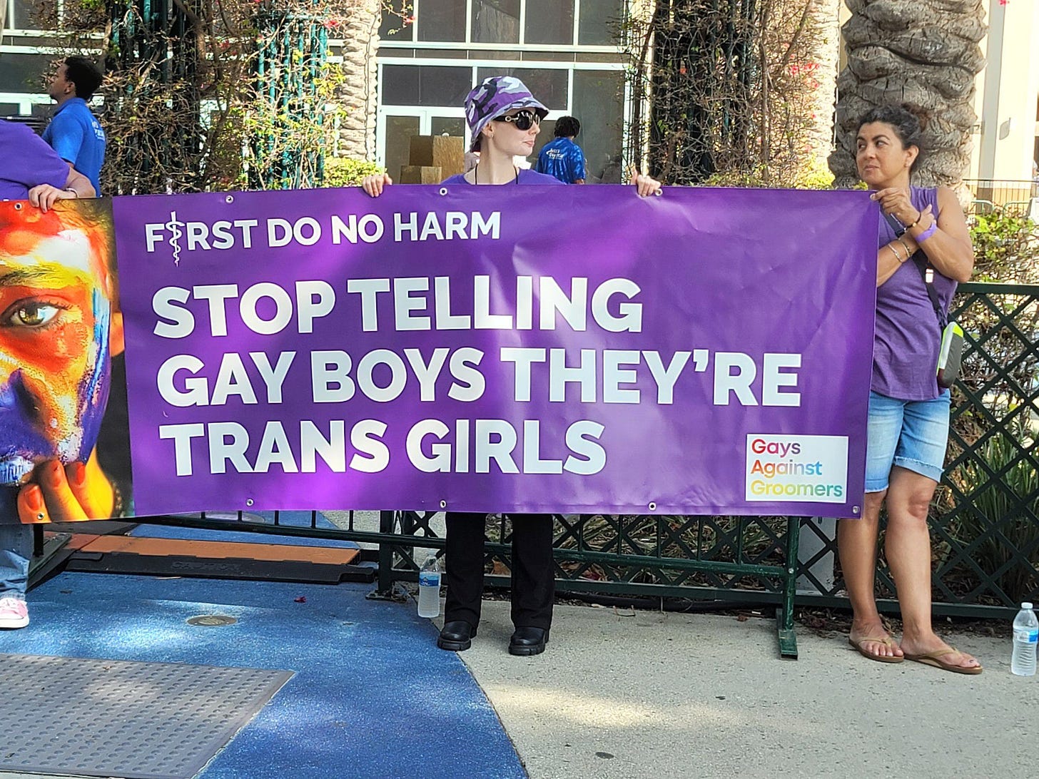 May be an image of 4 people, people standing, outdoors and text that says 'F$RST DO NO HARM STOP TELLING GAY BOYS THEY'RE TRANS GIRLS Gays Against Groomers'