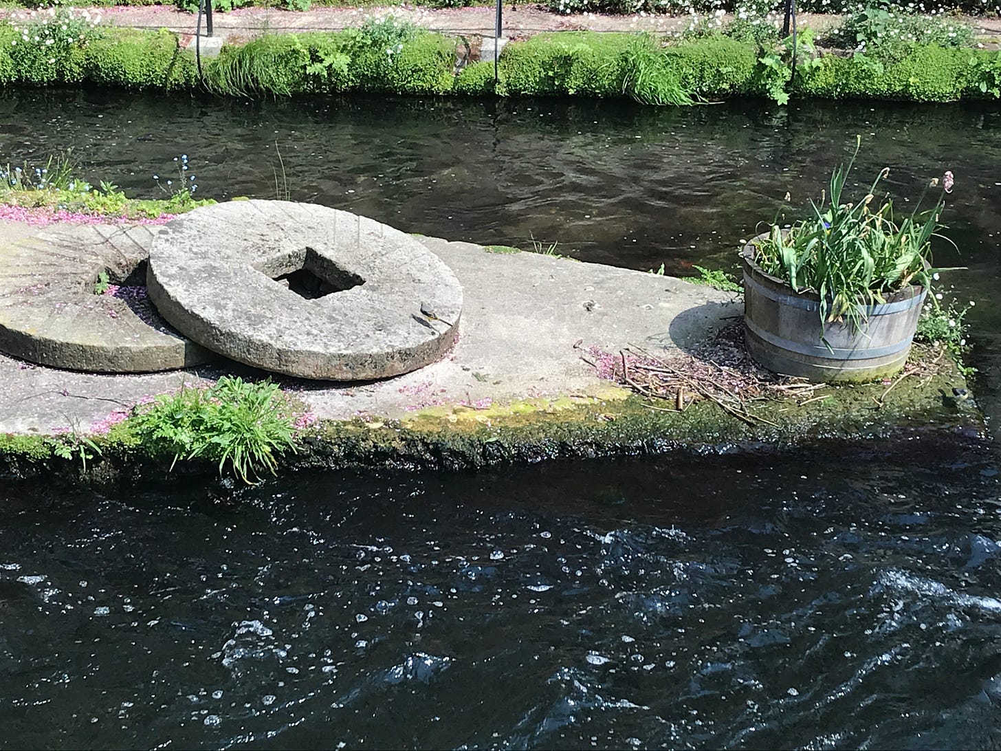 Millstones on an island in the River Itchen at Winchester City Mill. 