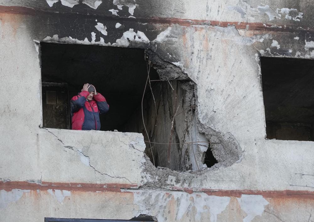 A man holds his head as he stands in his apartment in a multi-story house that was destroyed following a Russian attack in Kharkiv, Ukraine, Thursday, March 24, 2022. (AP Photo/Efrem Lukatsky)