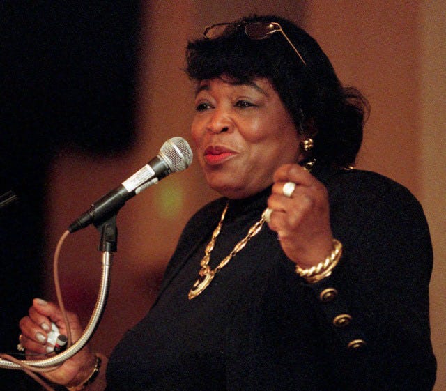 This image shows Dr. Betty Shabazz speaking at the microphone of a public event held sometime during the early 1990s. This image shows Dr. Betty Shabazz speaking at the microphone of a public event held sometime during the early 1990s.
