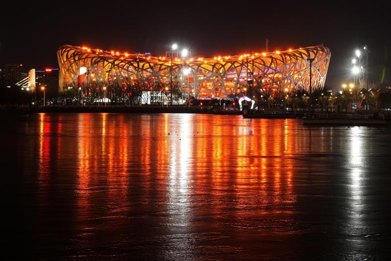 The Olympic Stadium is lit prior to the opening ceremony of the 2022 Winter Olympics, Friday, Feb. 4, 2022, in Beijing. (AP Photo/Mark Schiefelbein)