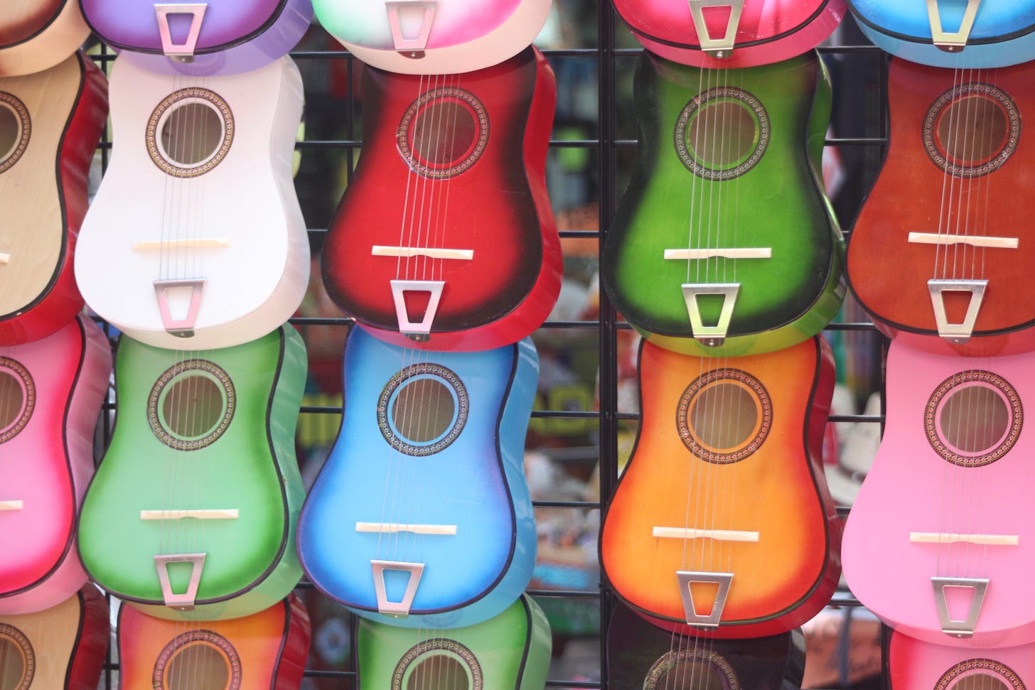 Lots of colourful ukuleles