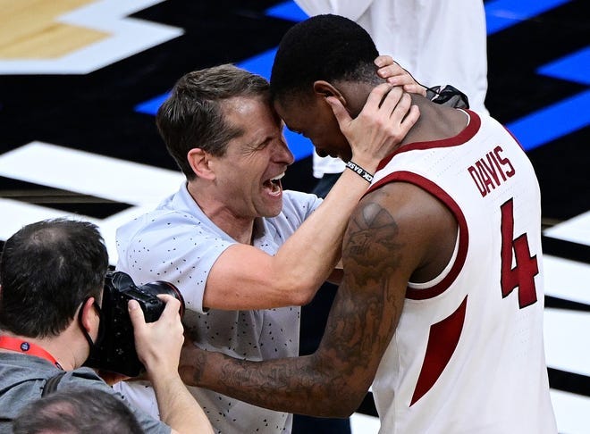 Arkansas coach Eric Musselman celebrates with guard Davonte Davis after the Razorbacks defeated Oral Roberts in the Sweet Sixteen of the 2021 NCAA Tournament at Bankers Life Fieldhouse.