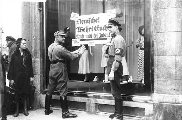 Picture of Germans with posters asking citizens to not shop at Jewish businesses Picture of Germans with posters asking citizens to not shop at Jewish businesses