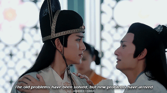 a gif from the cdrama The Untamed: jin guangyao is on the left and wears a hat indicating his office. To his right, nie huaisang is pretending to be drunk, and wails as he collapses on Jin Guangyao's shoulder: "The old problems have been solved, but new problems have arrived"