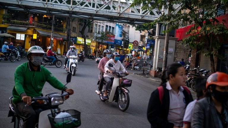Thuy Chi NGUYEN, a xe om driver, carries one of her regular customer through the streets of the Old Quarter on November 12, 2020 in Hanoi, Vietnam.