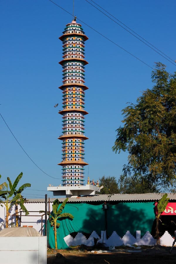 A 40-story chabutra near a highway. As with skyscrapers, tall birdhouses are a point of pride for the communities that build and showcase them.