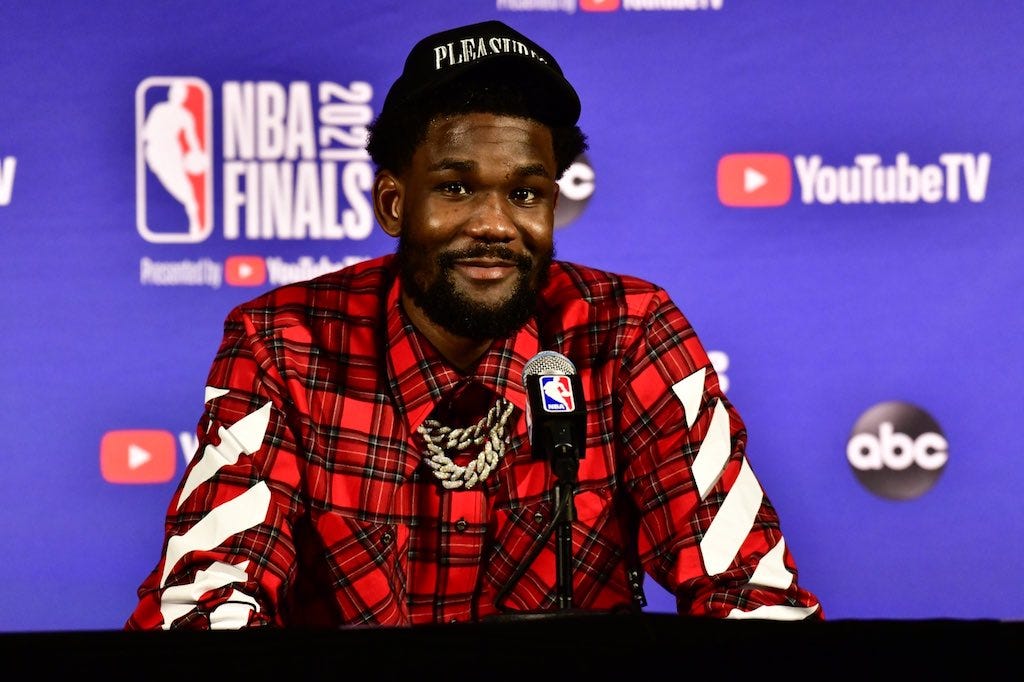 Suns center Deandre Ayton talks with reporters at the NBA Finals.