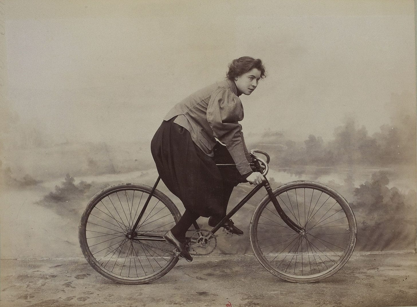 A historical photo of a French cyclist in bloomers.