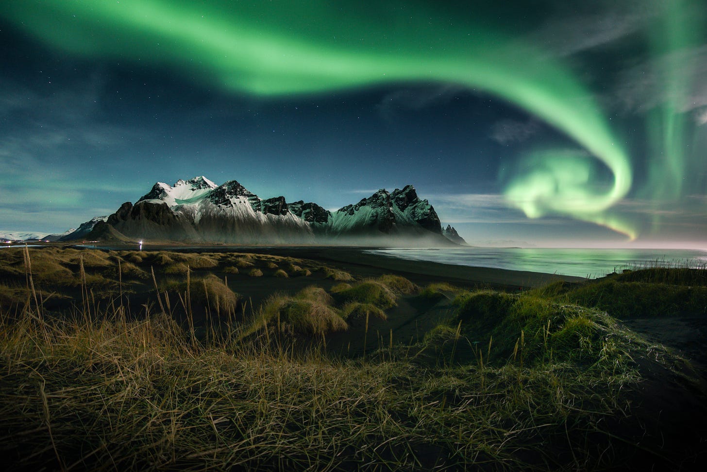Mountain and gorgeous curling green lights all around in the sky