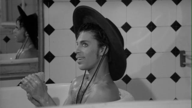 Prince in a bathtub, wearing a cowboy hat