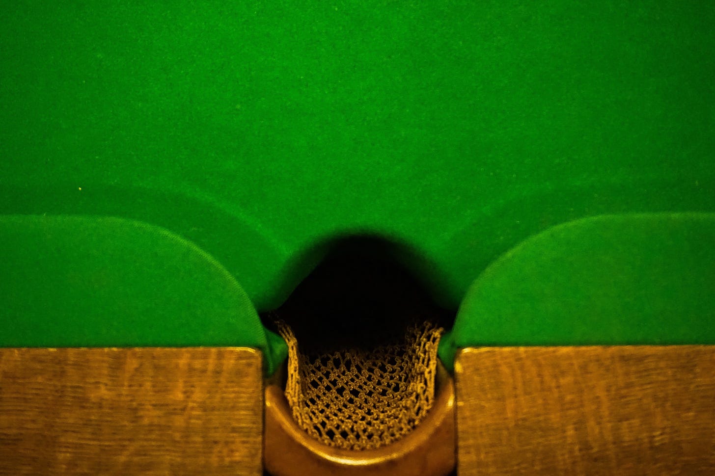 Classic antique style billiards table with knit pocket and Kelly green felt