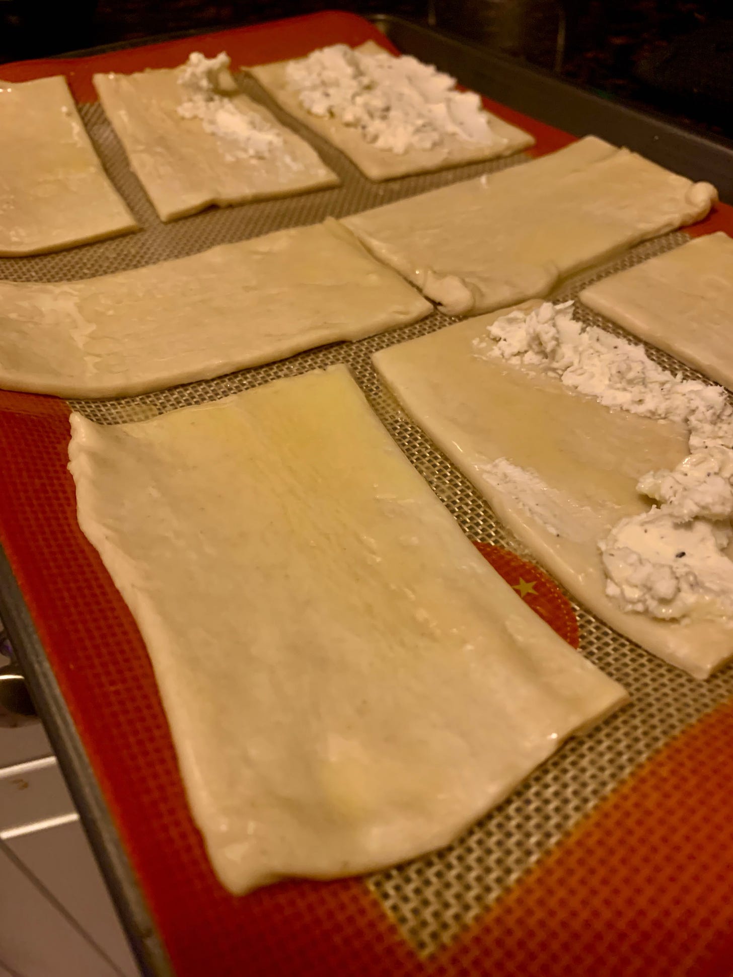 Angle view of puff pastry topped with goat cheese