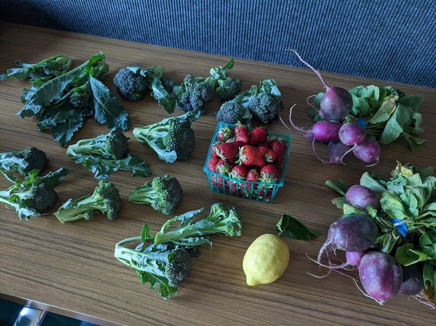 broccoli, lemon, strawberries and purple radish on a hotel desk in our room