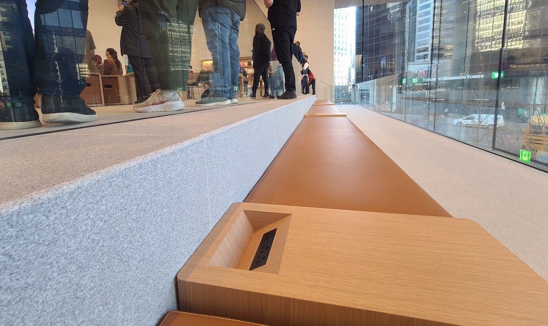 Seating with integrated power outlets at Apple Pacific Centre.