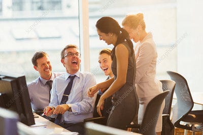 Laughing business people at computer in office - Stock Image - F016/7263 -  Science Photo Library