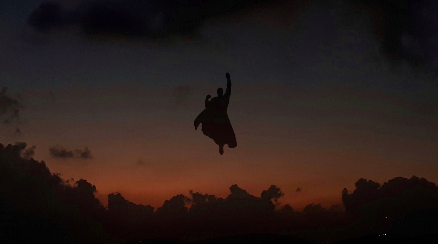 a silhouette of superman rising in the air 