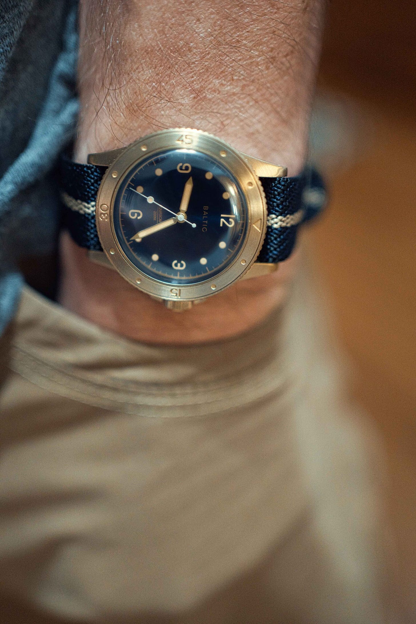 wrist shot of the baltic bronze on a crown and budle strap