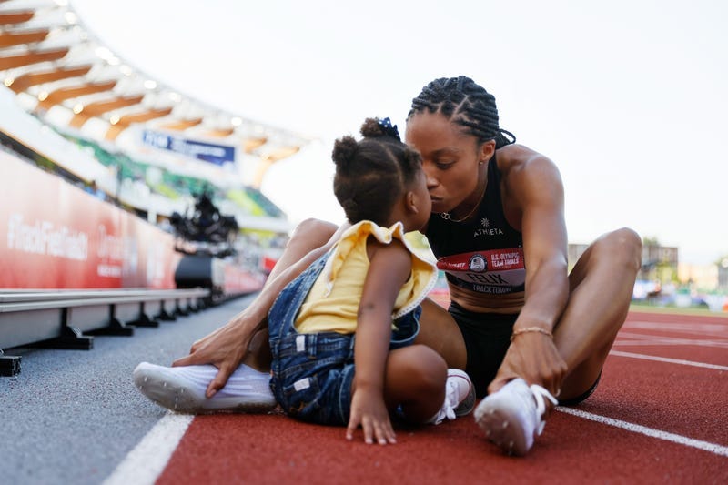 Allyson Felix kisses her daughter after a race.