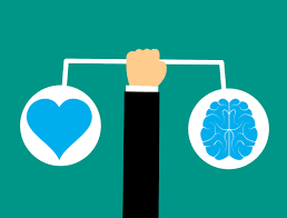 Picture of heart and brain on a balancing scale