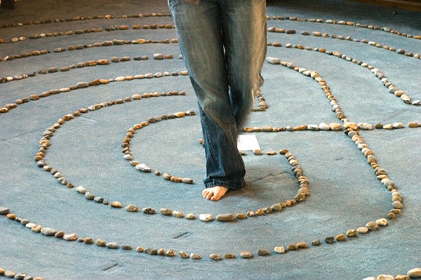 lady in a dance pose on a floor with stones laid in a pattern