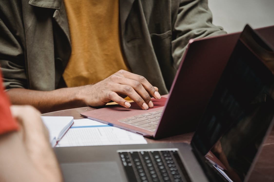 Free Crop faceless diverse male colleagues working on netbooks in office Stock Photo