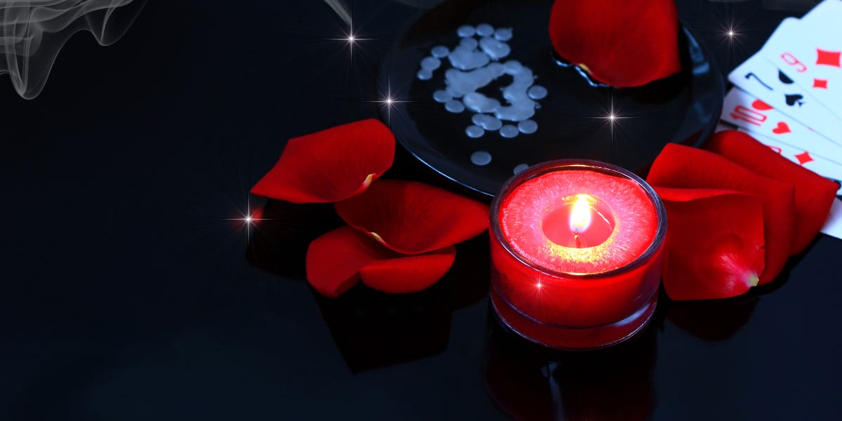 The image shows an incessant candle. Some rose petals are surrounding it. There are some beads and playing cards as well. The image is part of the article titled “How is shubh muhurta calculated?” authored by Anish Prasad and published at https://rationalastro.org