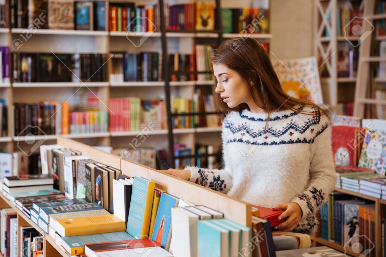 Portrait Of A Young Casual Woman Searching For A Book In Bookstore.. Stock  Photo, Picture And Royalty Free Image. Image 68979018.