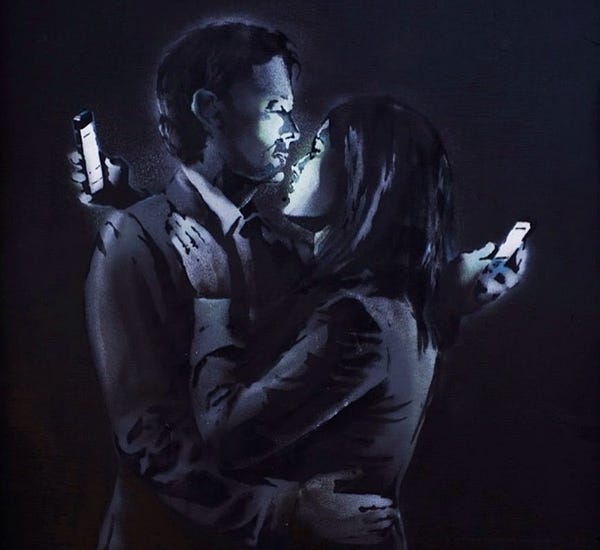 Image: Banksy's "Mobile Lovers:" a man and woman embrace, reading their phones over each other's shoulders
