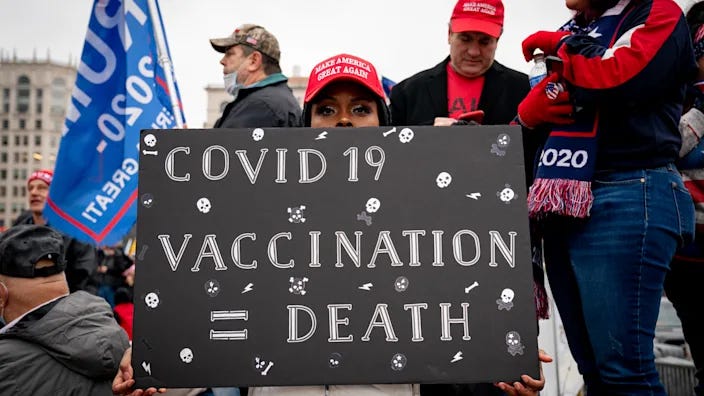 A supporter of President Donald Trump on Jan. 5 holds an anti-vaccine sign at a protest at Freedom Plaza in Washington, D.C.