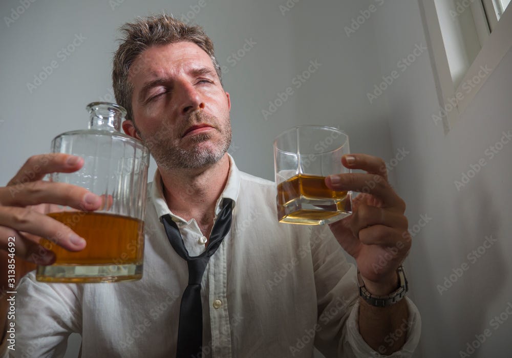 portrait of 30s to 40s alcoholic man in lose necktie drinking desperate  holding whiskey glass thoughtful drunk and depressed completely wasted in  alcohol addiction concept Stock Photo | Adobe Stock